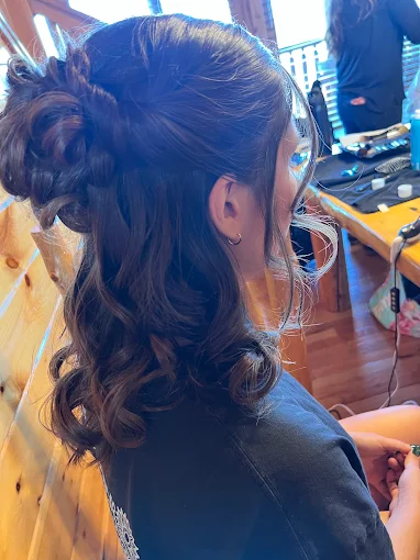 Half-up style with soft curls, done for a special occasion